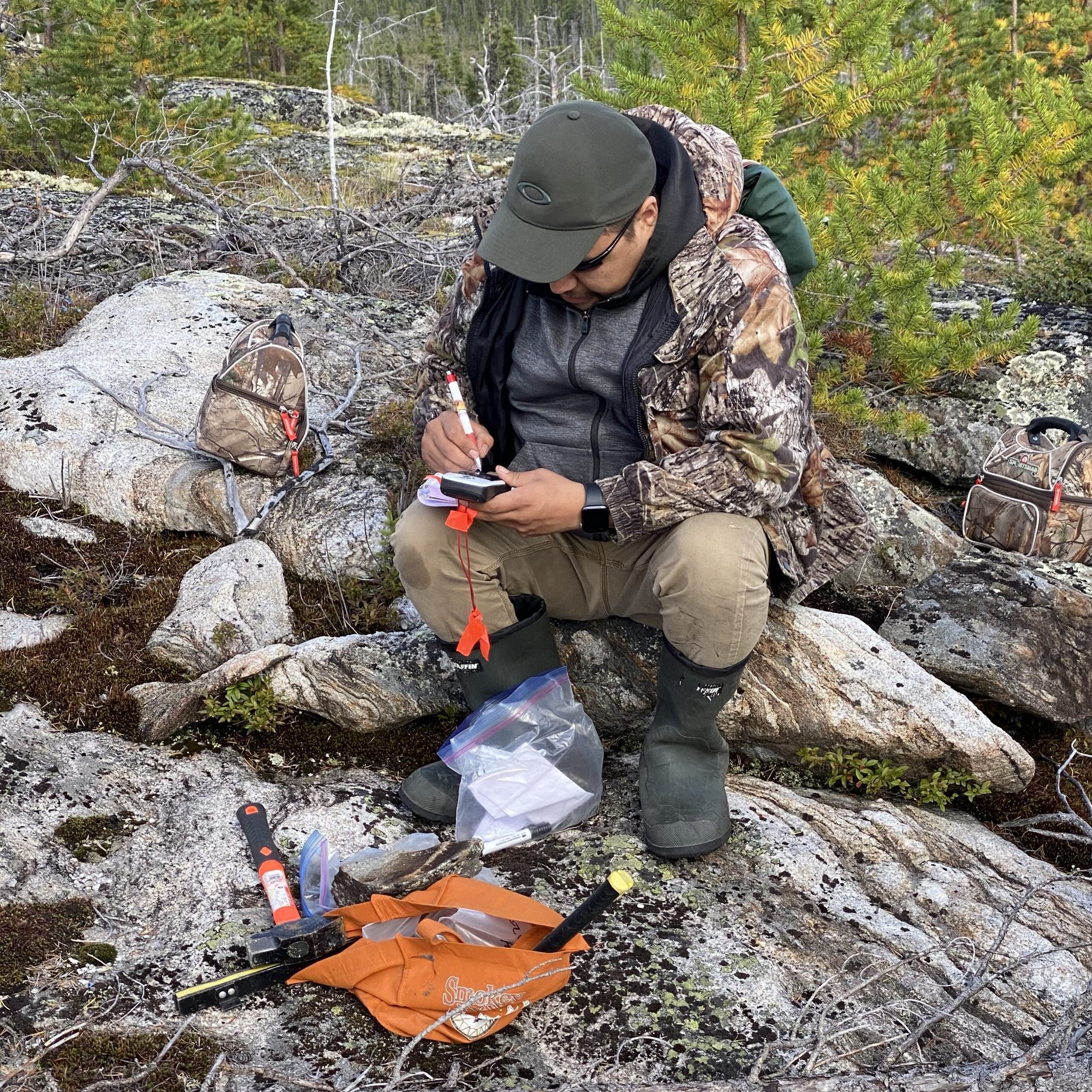 Cree prospector working in rocky terrain in Eeyou Istchee, James Bay, Quebec